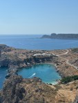 St Paul’s Bay in Rhodes with turquoise water surrounded by rocky cliffs near Lindos, Greece