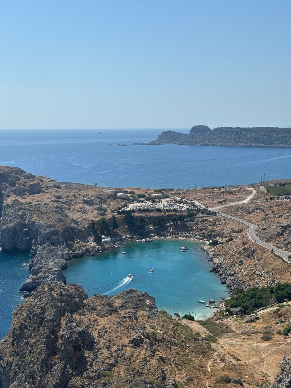 St Paul’s Bay in Rhodes with turquoise water surrounded by rocky cliffs near Lindos, Greece