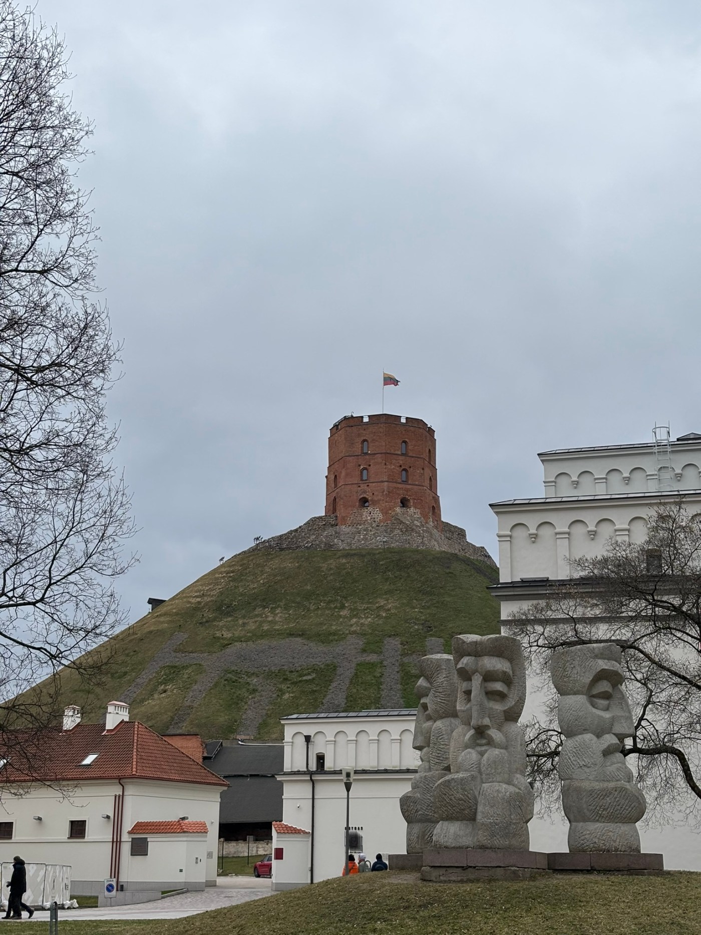 Gediminas Tower on a hill overlooking Vilnius Old Town under a grey sky